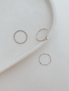Three silver rings on a white speckled plate