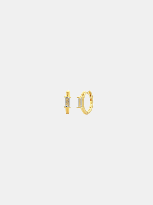 Gold hoop earrings on a light gray background