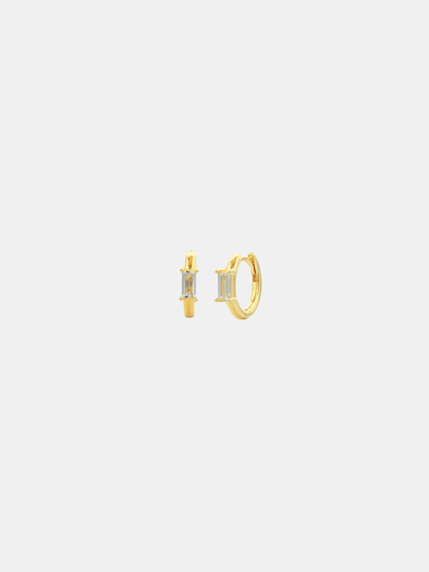 Gold hoop earrings on a light gray background