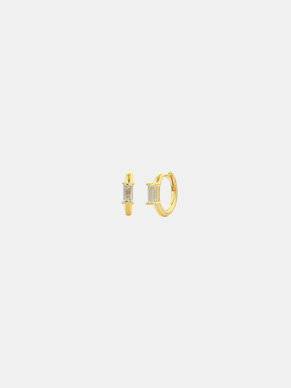 Gold hoop earrings on a light gray background