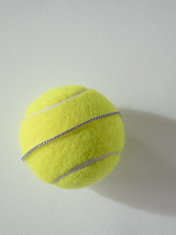 Yellow tennis ball on a white background